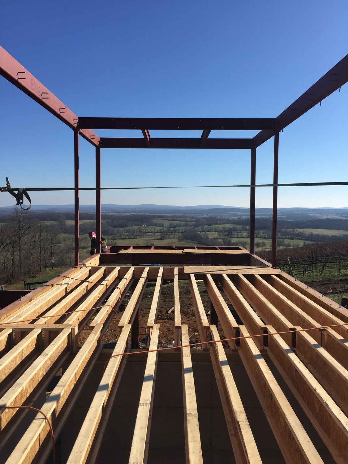 Steel frame and floor joists of Blue Ridge House cantilevered over the Virginia valley during construction